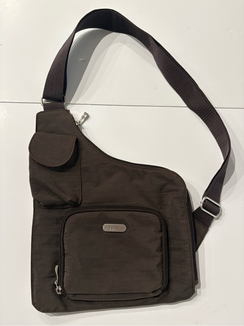 Baggallini Crossbody Sling Bag in Dark Brown with red lining, pockets, adj strap